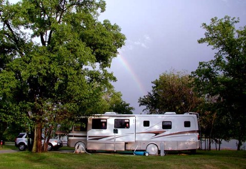 A rainbow stretches over Hickory Creek Campground
